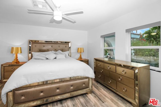 a spacious bedroom with a bed and a window