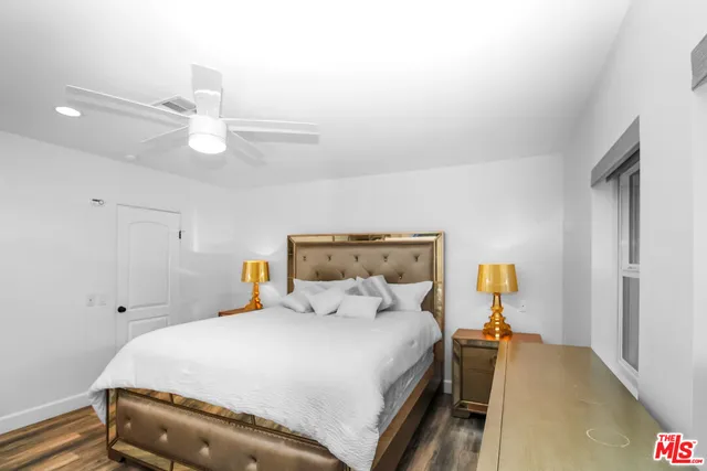 a bedroom with a bed and a large window