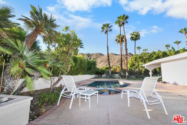 a patio with water table and chairs