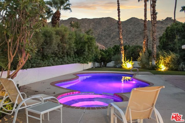 a view of swimming pool with outdoor seating