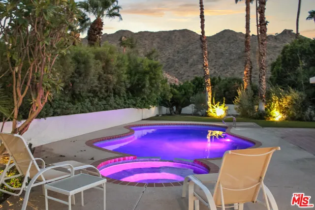 a view of swimming pool with outdoor seating