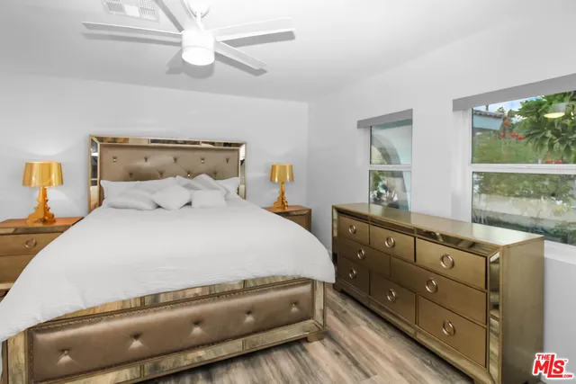 a white bed sitting in a room next to a window