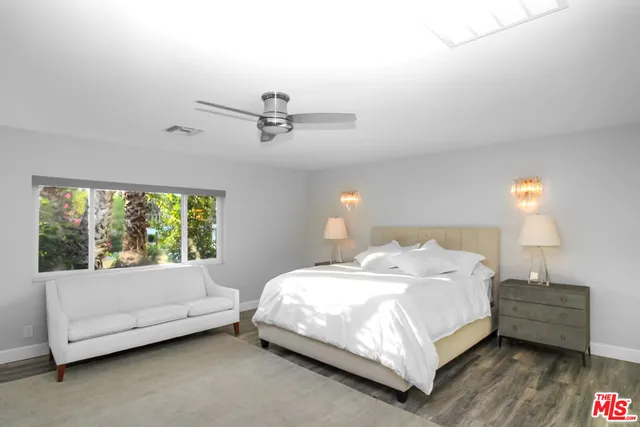 a bedroom with a bed and a couch