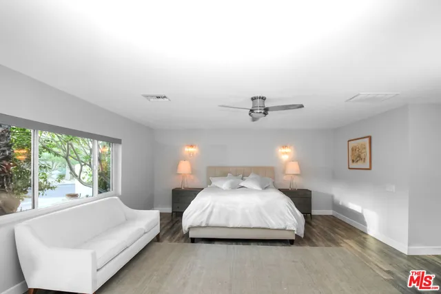 a bedroom with a bed and a night stand