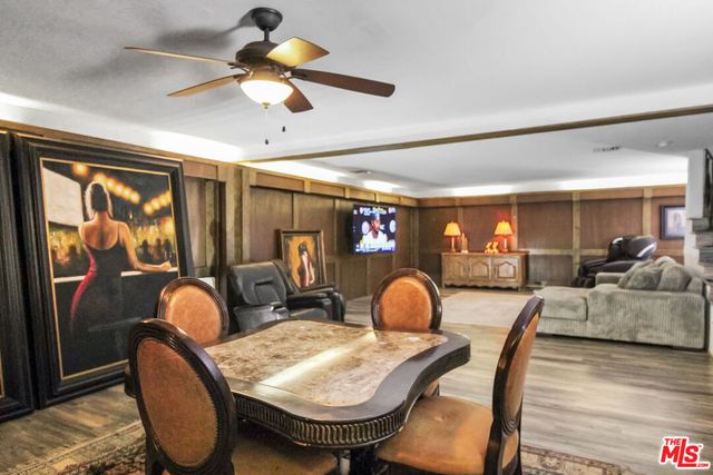 a living room with furniture a chandelier and a large window