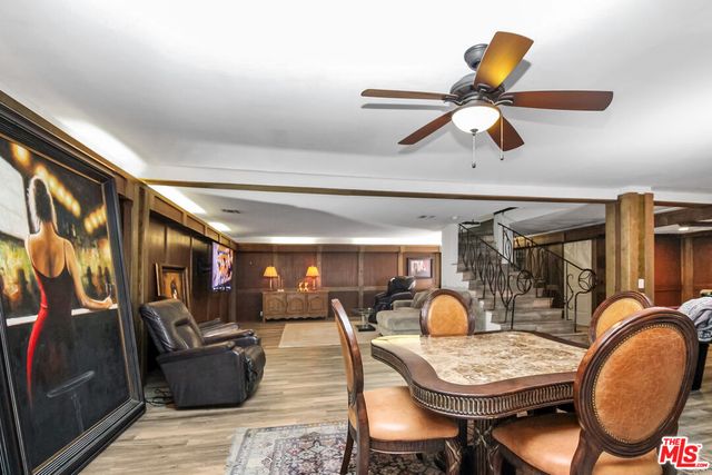 a dining room with furniture and wooden floor