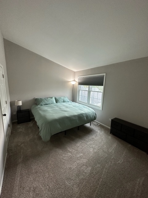 1929 Stillwater Road Arlington Heights, IL 60004 - Photo 14 of 29 a spacious bedroom with a bed and a window