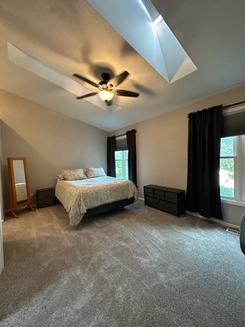 1929 Stillwater Road Arlington Heights, IL 60004 - Photo 16 of 29 a spacious bedroom with a bed and a ceiling fan