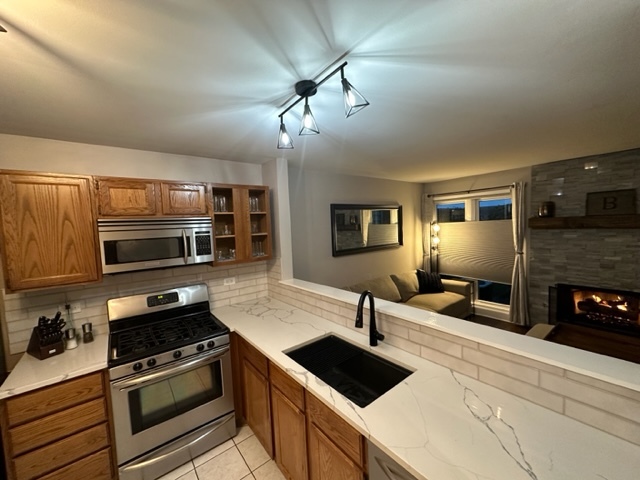 1929 Stillwater Road Arlington Heights, IL 60004 - Photo 8 of 29 a kitchen with a stove and a microwave