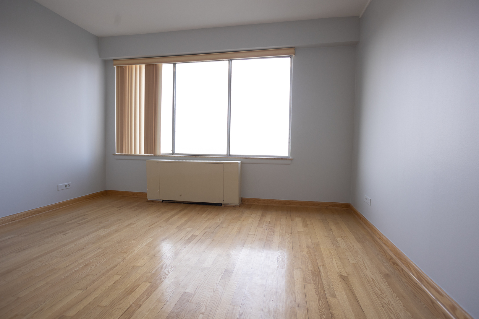 Undisclosed Address Chicago, IL 60645 - Photo 17 of 20 an empty room with wooden floor and windows