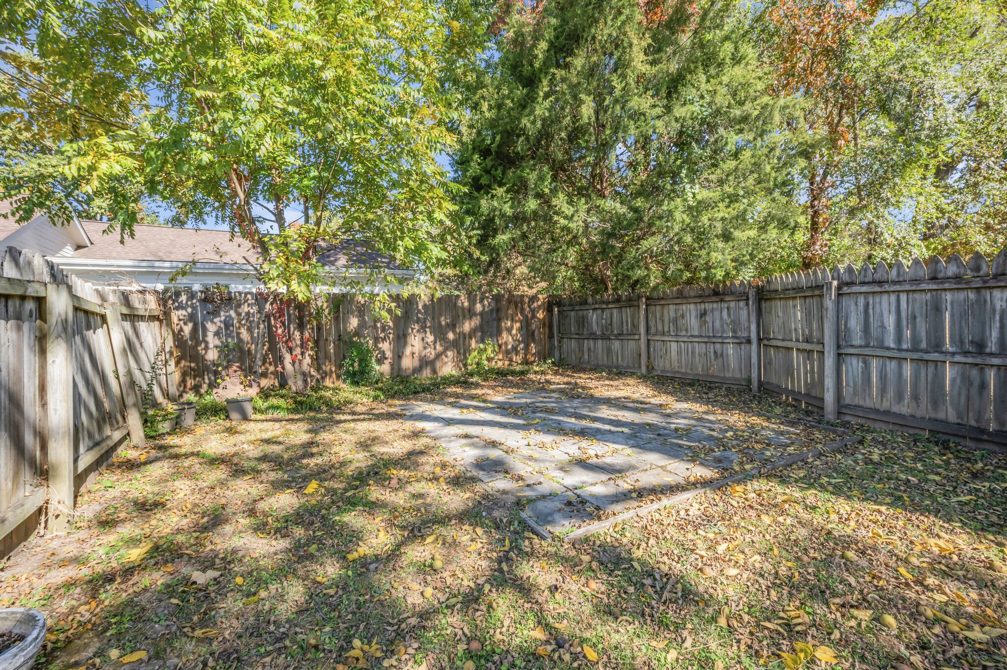 1231 Adams Street Franklin, TN 37064 - Photo 25 of 27 a view of a backyard with large trees and wooden fence