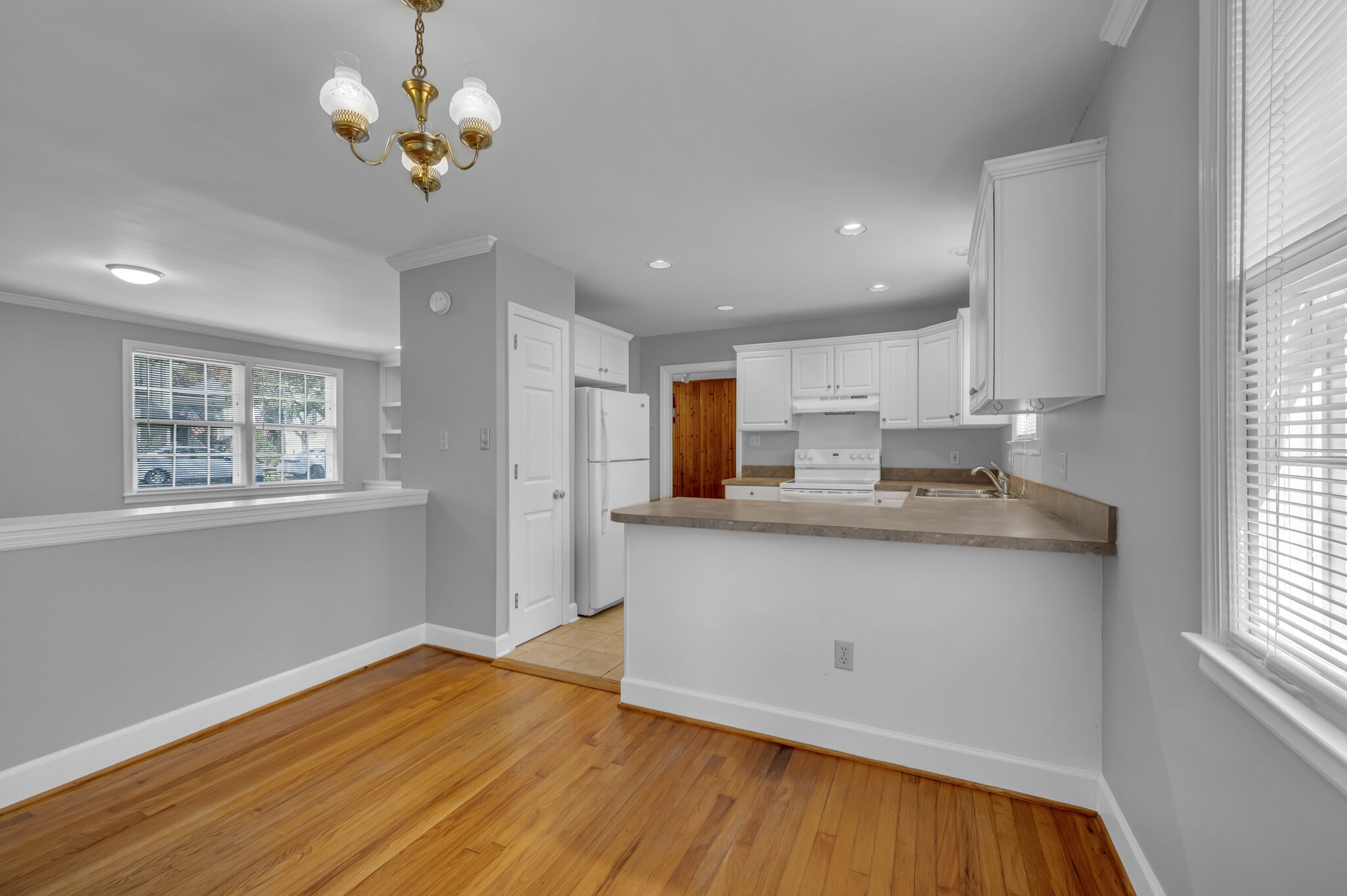 1231 Adams Street Franklin, TN 37064 - Photo 3 of 27 a kitchen with stainless steel appliances granite countertop a sink a stove a refrigerator cabinets and living room view