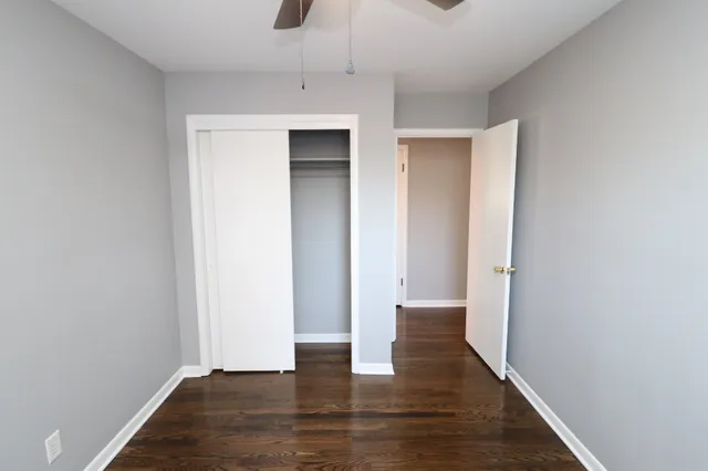 a view of a room with wooden floor and windows
