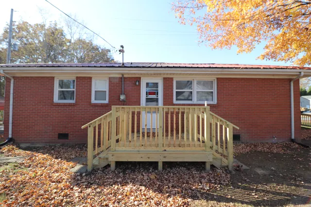 a view of a house with a wooden deck