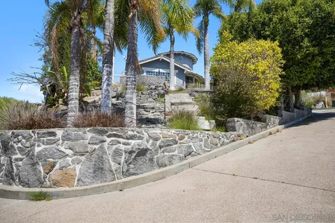 a view of a house with a yard and sitting area