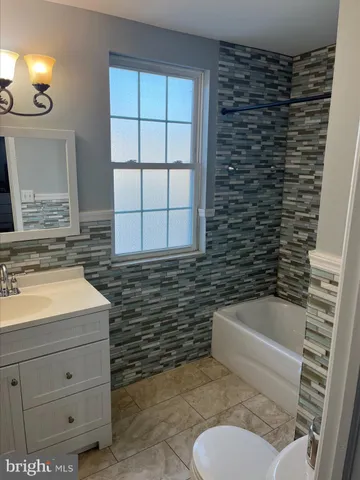 a bathroom with a sink a toilet and bathtub