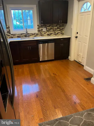 a view of kitchen with granite countertop cabinets and a sink