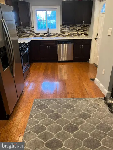 a kitchen with granite countertop a stove and a refrigerator