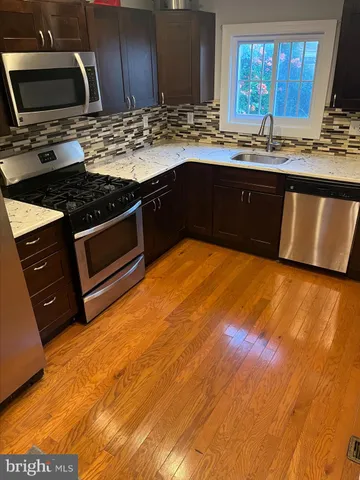 a kitchen with stainless steel appliances granite countertop a sink stove and granite counter top