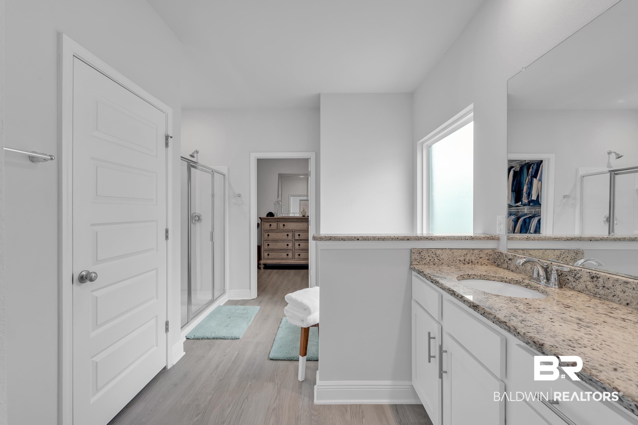 8774 Primland Boulevard Foley, AL 36535 - Photo 20 of 49 Bathroom with a shower stall, vanity, a spacious closet, and light wood-style floors