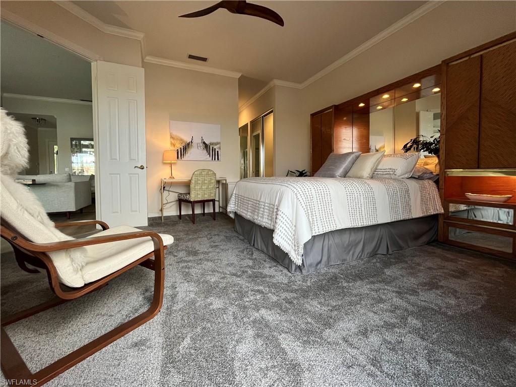 5477 Freeport Lane Naples, FL 34119 - Photo 12 of 36 a spacious bedroom with a bed and window