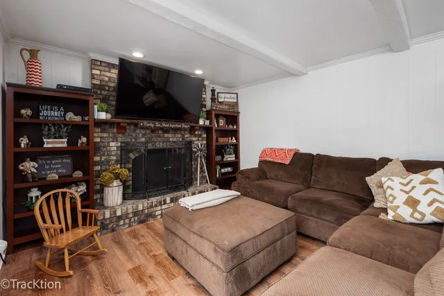 a living room with furniture a flat screen tv and a fireplace