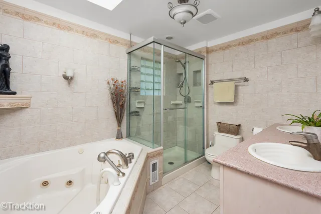 a bathroom with a tub sink and mirror