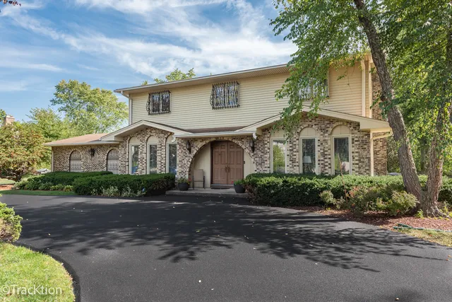 a front view of a house with a garden