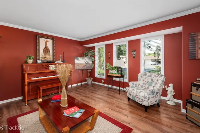 a living room with furniture a window and wooden floor