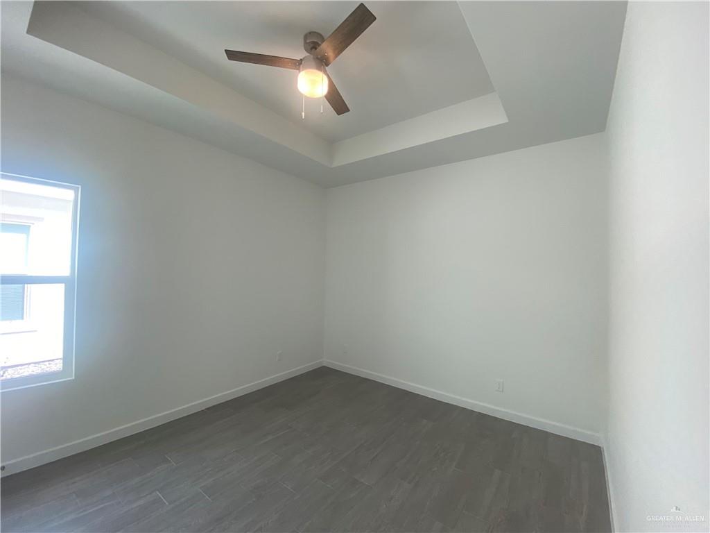 1408 Marcela Drive, Unit 3 Weslaco, TX 78599 - Photo 5 of 10 an empty room with a window and a fan
