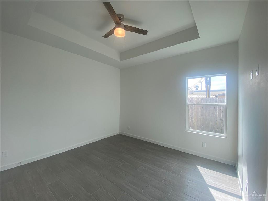 1408 Marcela Drive, Unit 3 Weslaco, TX 78599 - Photo 6 of 10 an empty room with a window and ceiling fan