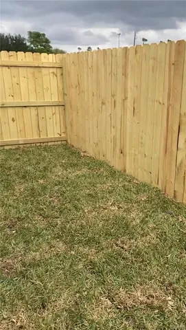 a view of a room with wooden floor and a window