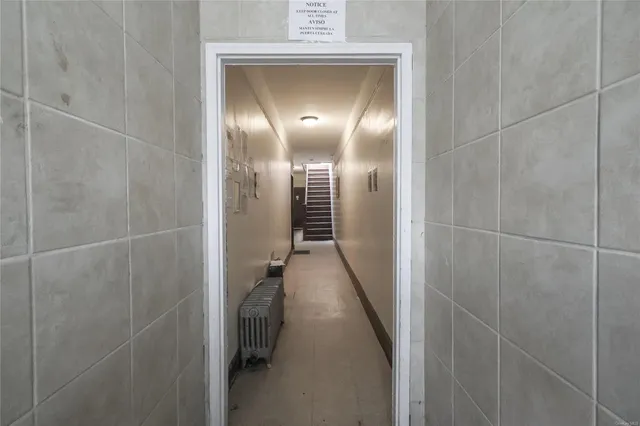 a view of entryway and gallery with wooden floor