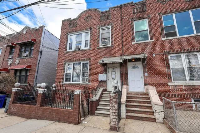 a front view of a brick building with many windows