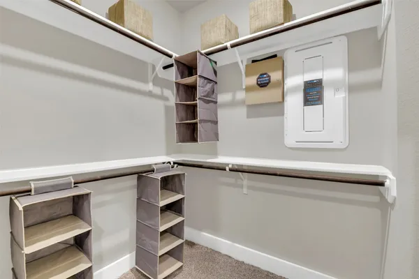 a view of walk in closet with empty racks