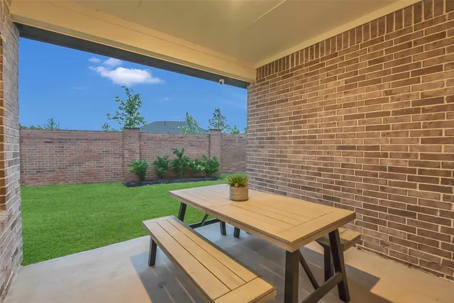 a view of a patio with a table and chairs
