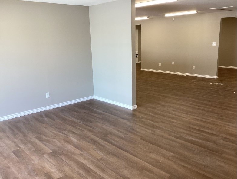 1010 1st Street East Humble, TX 77338 - Photo 15 of 49 an empty room with wooden floor and windows