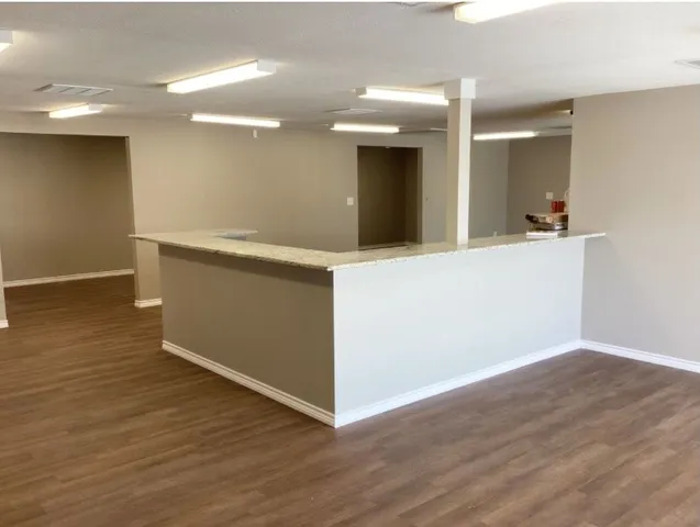 a view of a kitchen with a sink and large window