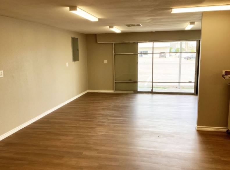 1010 1st Street East Humble, TX 77338 - Photo 41 of 49 a view of an empty room with wooden floor and a window