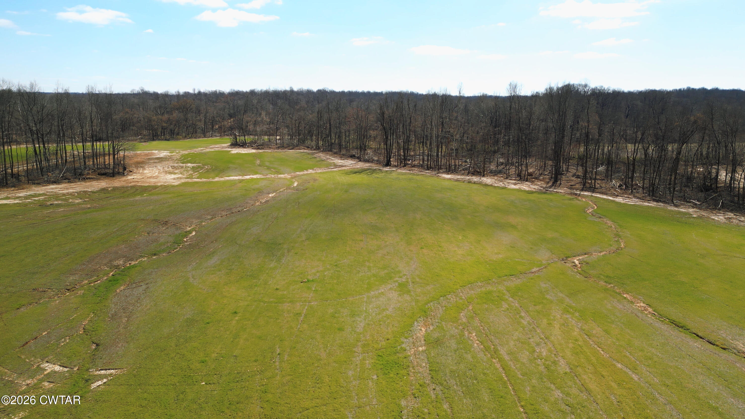 a view of a swimming pool with a yard and wooden fence