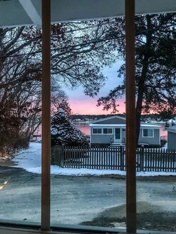 a view of balcony with floor to ceiling window wooden fence