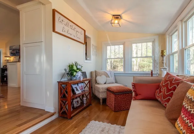 a living room with furniture lamp and window