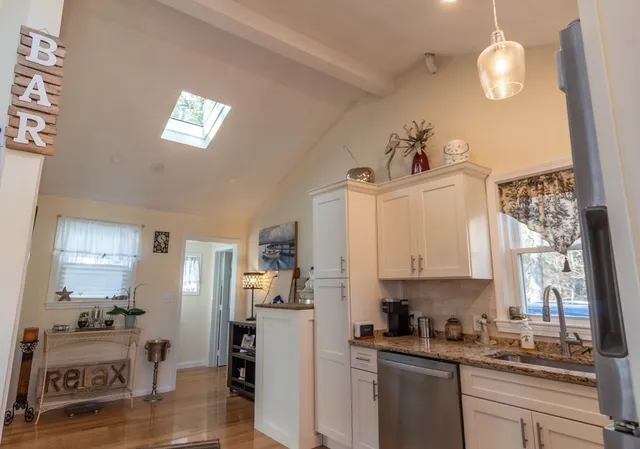 a kitchen with refrigerator and window
