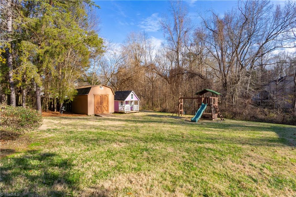 2833 Pickering Road Greensboro, NC 27407 - Photo 22 of 27 Back yard includes swing set and storage shed with wiring.