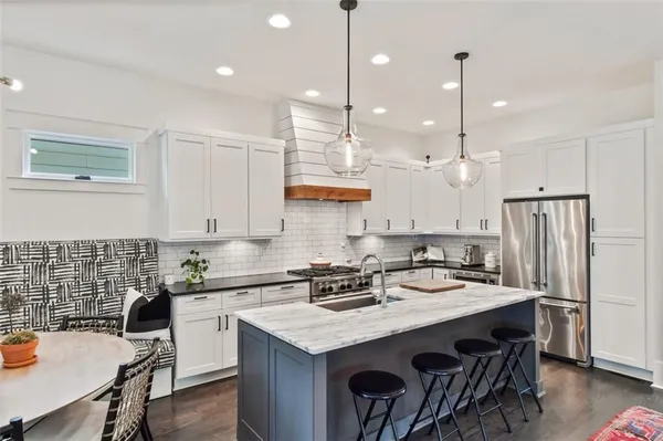 a kitchen with stainless steel appliances granite countertop a sink stove and cabinets