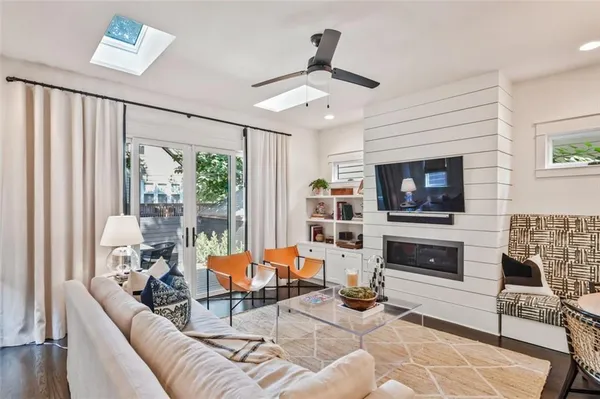 a living room with furniture a fireplace and a window
