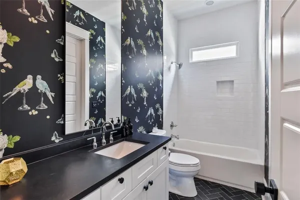 a kitchen that has a lot of cabinets in it and wooden floors