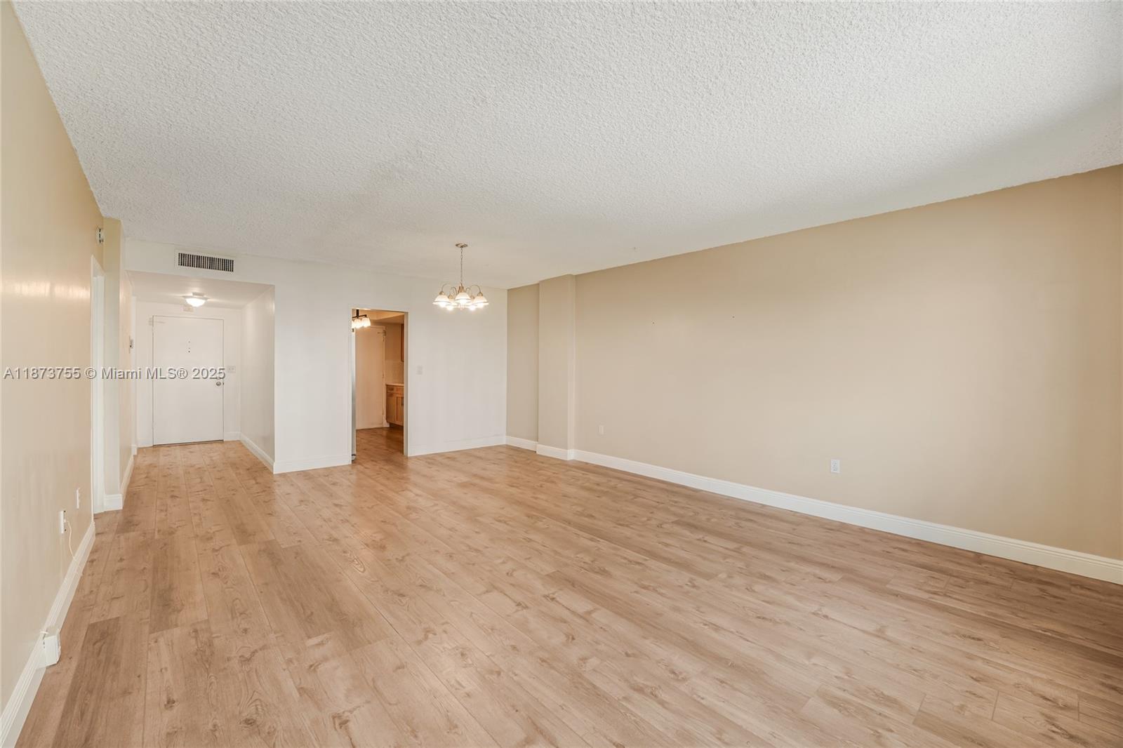 1700 Northeast 105th Street, Unit 505 Miami Shores, FL 33138 - Photo 13 of 20 a view of an empty room with wooden floor