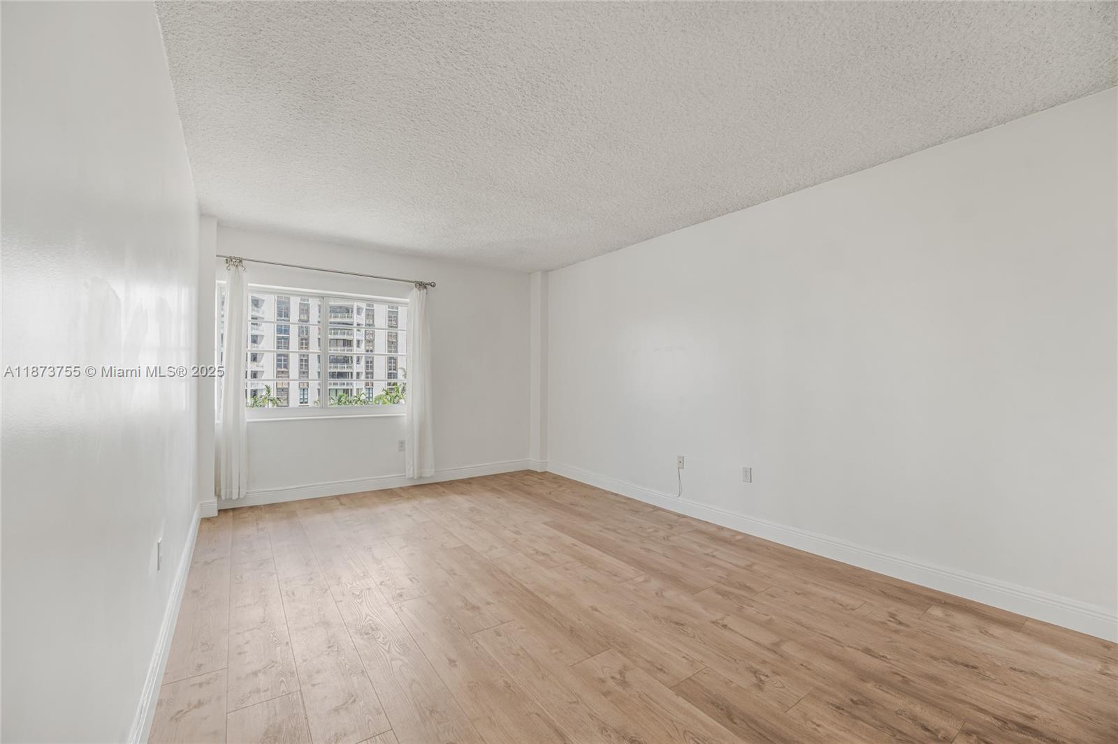 1700 Northeast 105th Street, Unit 505 Miami Shores, FL 33138 - Photo 20 of 20 an empty room with windows