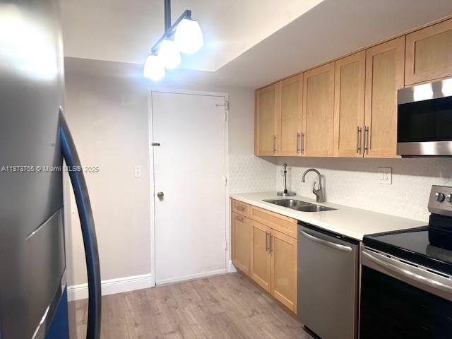 1700 Northeast 105th Street, Unit 505 Miami Shores, FL 33138 - Photo 7 of 20 a kitchen with sink a microwave and cabinets